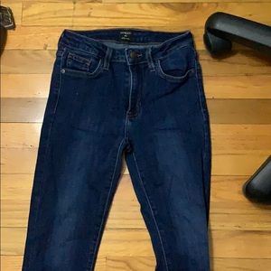 dark blue jeans with fringe at ends